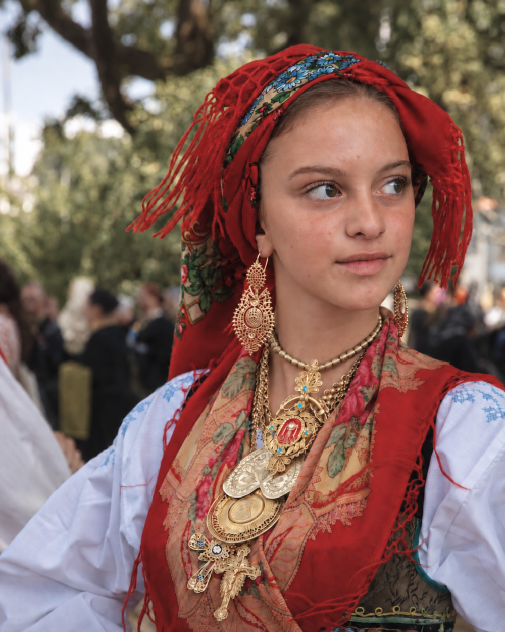 Portrait in a red Viana headscarf with gold filigree earrings